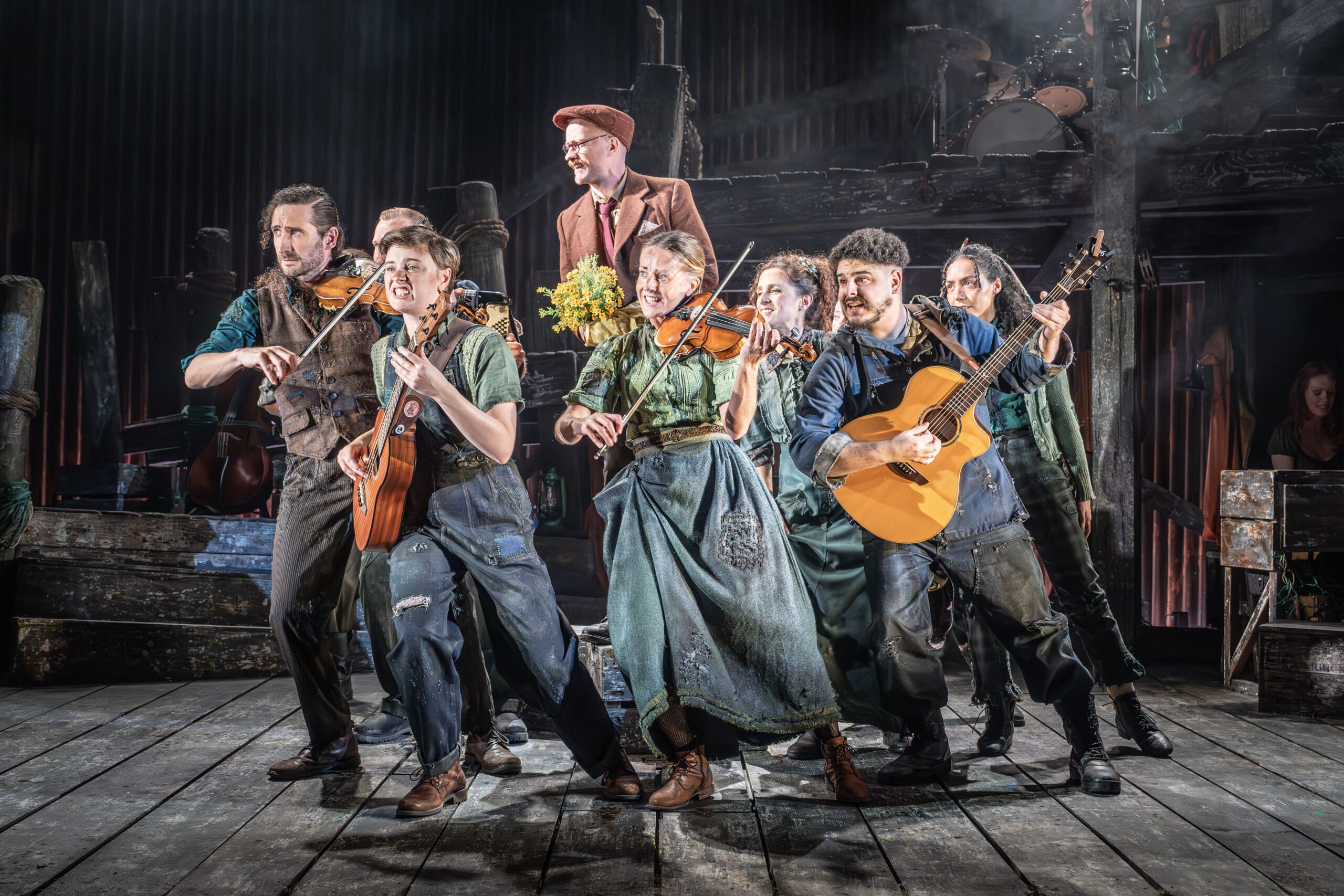 The cast of The Curious Case of Benjamin Button onstage playing musical instruments